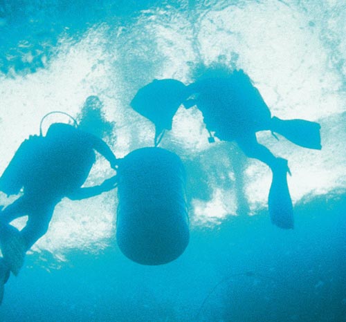 Divers recovering a drum